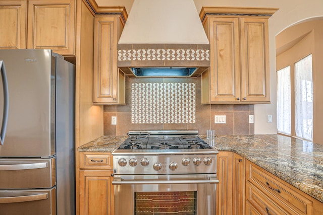 1624 23rd Ave SE, Rio Rancho, NM 87124 - kitchen featuring appliances with stainless steel finishes, premium range hood, backsplash, and dark stone counters