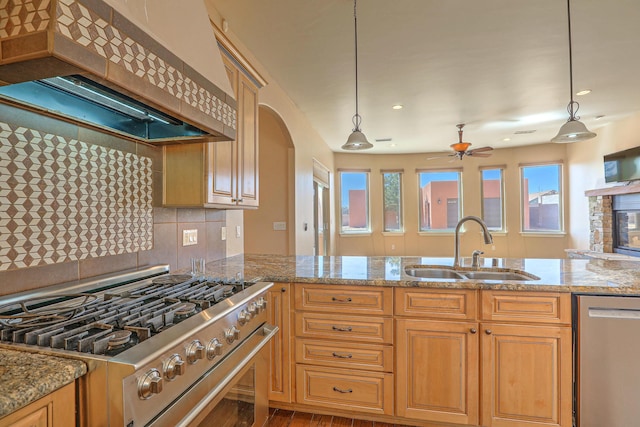 1624 23rd Ave SE, Rio Rancho, NM 87124 - kitchen featuring stainless steel appliances, custom range hood, a sink, ceiling fan, and light stone countertops