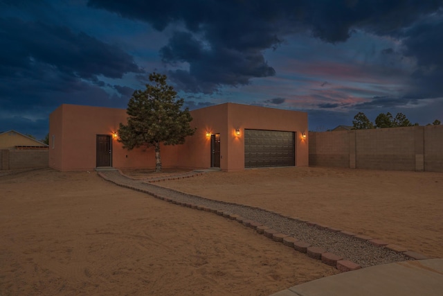 1624 23rd Ave SE, Rio Rancho, NM 87124 - southwest-style home featuring stucco siding, dirt driveway, and an attached garage