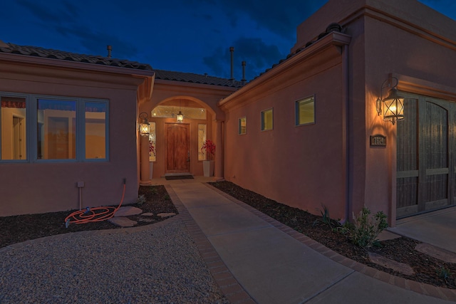 1624 23rd Ave SE, Rio Rancho, NM 87124 - view of exterior entry with a tile roof and stucco siding