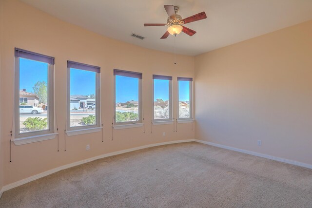 1624 23rd Ave SE, Rio Rancho, NM 87124 - spare room with light carpet, plenty of natural light, ceiling fan, and baseboards