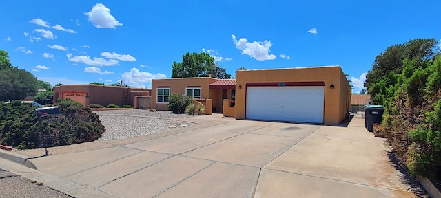 10017 Boulder St NW, Albuquerque, NM 87114 - adobe home featuring stucco siding, a garage, concrete driveway, and a tile roof