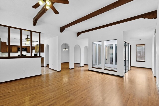 10017 Boulder St NW, Albuquerque, NM 87114 - unfurnished living room with ceiling fan, light wood-style flooring, beamed ceiling, and arched walkways