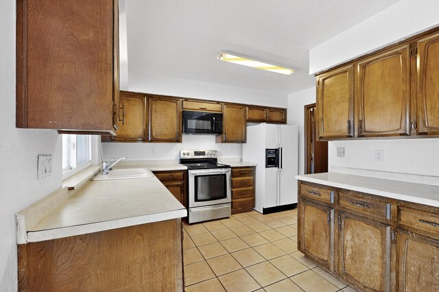10017 Boulder St NW, Albuquerque, NM 87114 - kitchen featuring electric stove, white refrigerator with ice dispenser, black microwave, light tile patterned floors, and light countertops