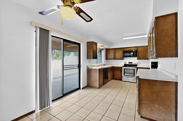 10017 Boulder St NW, Albuquerque, NM 87114 - kitchen with black appliances, light countertops, light tile patterned flooring, ceiling fan, and a textured ceiling