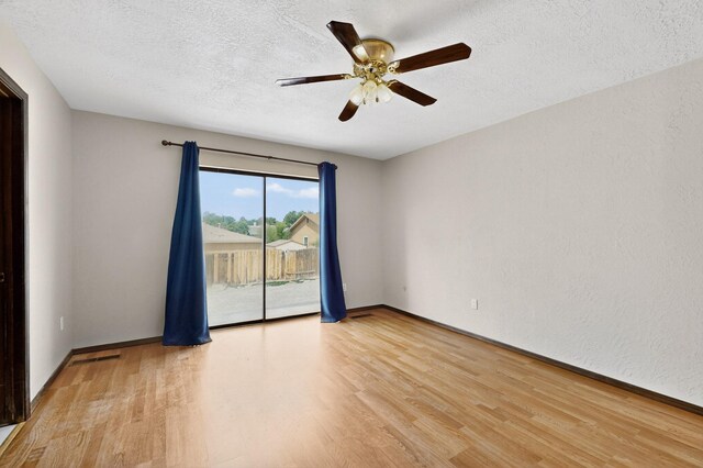 10017 Boulder St NW, Albuquerque, NM 87114 - unfurnished room with wood finished floors, ceiling fan, and a textured ceiling