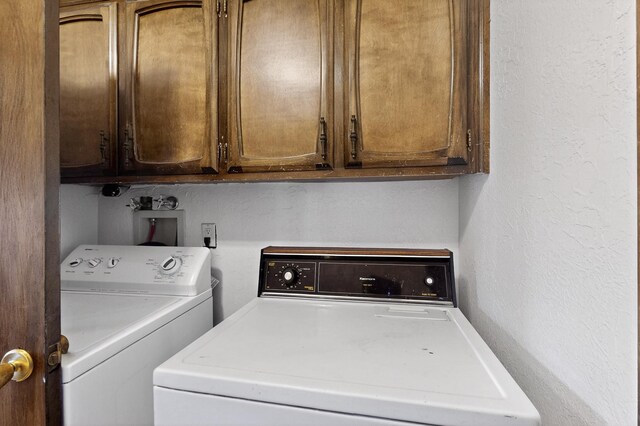 10017 Boulder St NW, Albuquerque, NM 87114 - laundry room with independent washer and dryer, a textured wall, and cabinet space