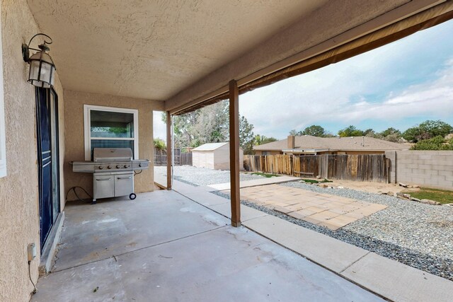 10017 Boulder St NW, Albuquerque, NM 87114 - fenced backyard with a patio area and a storage shed