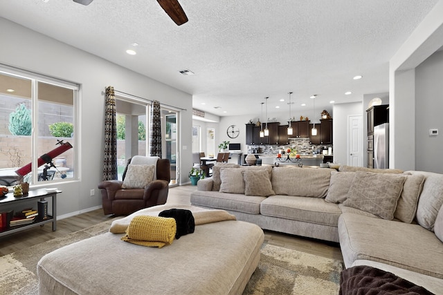 4028 Colina Roja Ln NE, Rio Rancho, NM 87124 - living room featuring a ceiling fan, a textured ceiling, light wood-type flooring, and recessed lighting