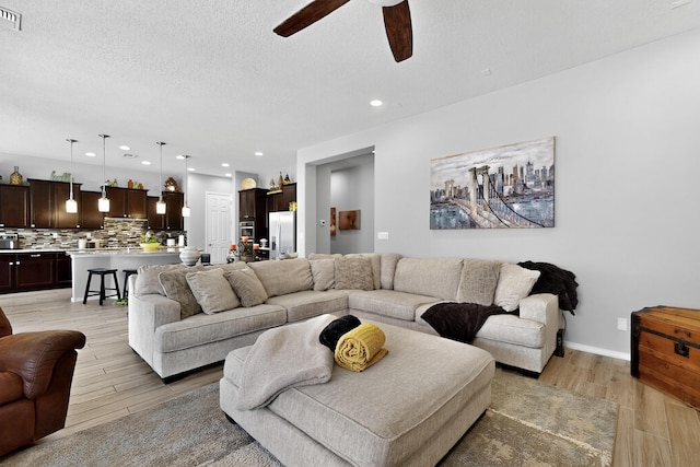 4028 Colina Roja Ln NE, Rio Rancho, NM 87124 - living area with ceiling fan, light wood-style floors, recessed lighting, and a textured ceiling