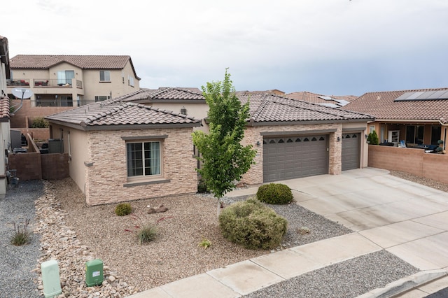 4028 Colina Roja Ln NE, Rio Rancho, NM 87124 - view of front of home featuring stucco siding, a tile roof, an attached garage, and concrete driveway