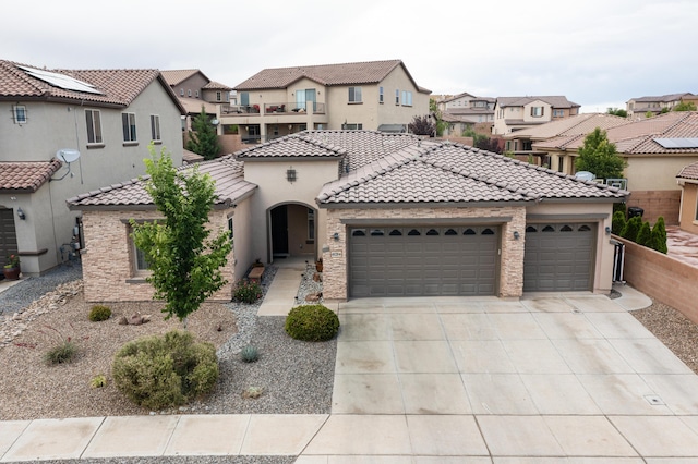 4028 Colina Roja Ln NE, Rio Rancho, NM 87124 - view of front of house featuring a garage, driveway, a tiled roof, a residential view, and stucco siding