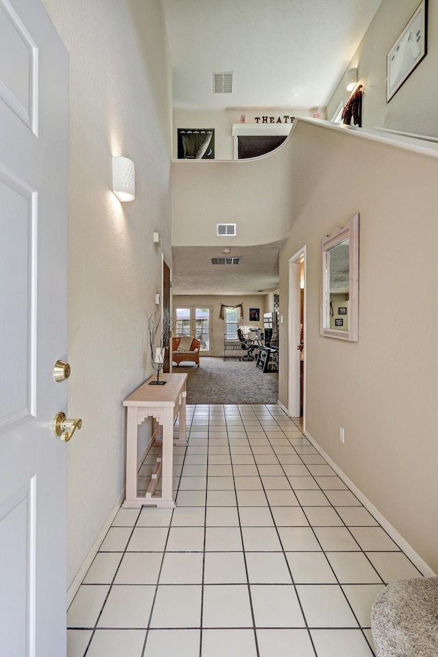 12323 Haines Ave NE, Albuquerque, NM 87112 - entrance foyer featuring a towering ceiling, light tile patterned floors, light colored carpet, and baseboards