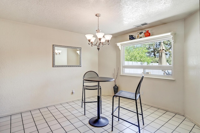 12323 Haines Ave NE, Albuquerque, NM 87112 - dining area with a textured ceiling and a chandelier