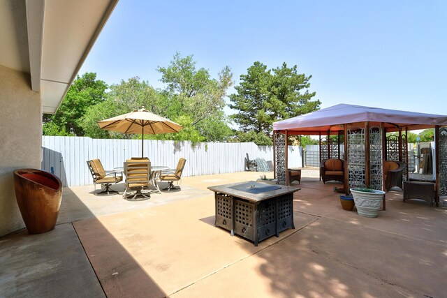 12323 Haines Ave NE, Albuquerque, NM 87112 - fenced backyard featuring a gazebo, a patio, and a fire pit