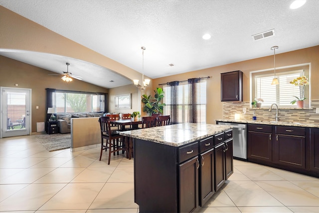 8031 Corn Mountain Pl NW, Albuquerque, NM 87114 - kitchen with dishwasher, a sink, lofted ceiling, tasteful backsplash, and plenty of natural light