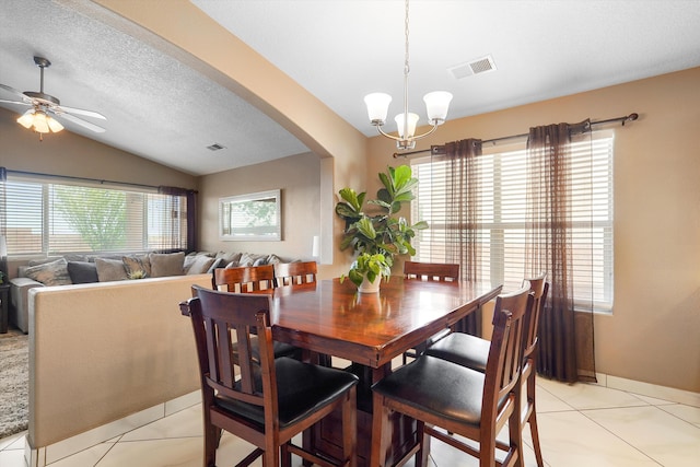 8031 Corn Mountain Pl NW, Albuquerque, NM 87114 - dining area with vaulted ceiling, a chandelier, light tile patterned floors, arched walkways, and ceiling fan
