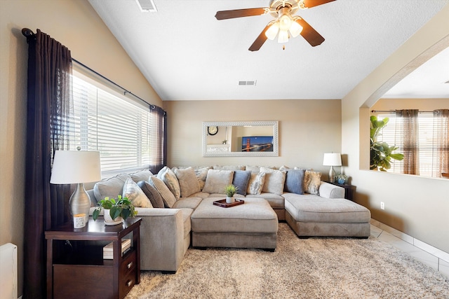 8031 Corn Mountain Pl NW, Albuquerque, NM 87114 - living room featuring plenty of natural light, a ceiling fan, tile patterned floors, arched walkways, and lofted ceiling