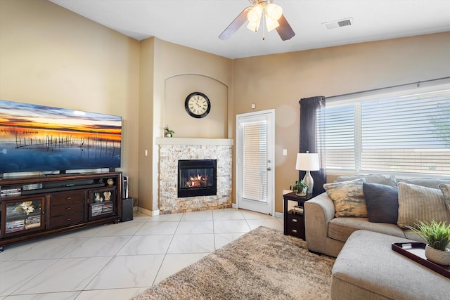 8031 Corn Mountain Pl NW, Albuquerque, NM 87114 - living area featuring ceiling fan, a tile fireplace, and baseboards