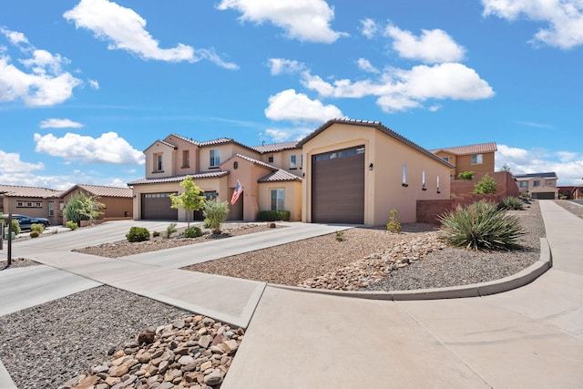 4118 Pico Norte Ln NE, Rio Rancho, NM 87124 - mediterranean / spanish home with driveway, stucco siding, a tile roof, and an attached garage