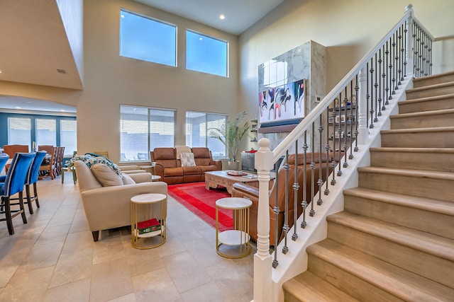 2350 Sandra Loop NE, Rio Rancho, NM 87144 - tiled living room with a high ceiling, stairway, and recessed lighting