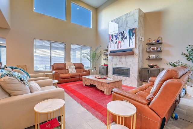 2350 Sandra Loop NE, Rio Rancho, NM 87144 - living room with a premium fireplace, a towering ceiling, and tile patterned flooring