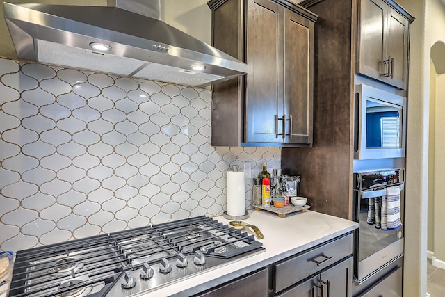 2350 Sandra Loop NE, Rio Rancho, NM 87144 - kitchen featuring exhaust hood, stainless steel appliances, dark brown cabinets, light countertops, and tasteful backsplash