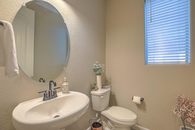 2350 Sandra Loop NE, Rio Rancho, NM 87144 - half bath featuring toilet, a sink, and baseboards