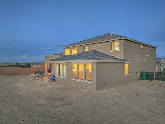 2350 Sandra Loop NE, Rio Rancho, NM 87144 - back of house featuring stucco siding and a fenced backyard