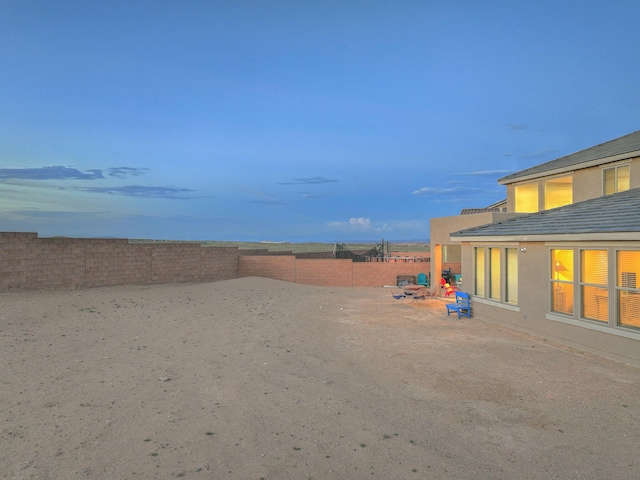 2350 Sandra Loop NE, Rio Rancho, NM 87144 - yard at dusk with a fenced backyard