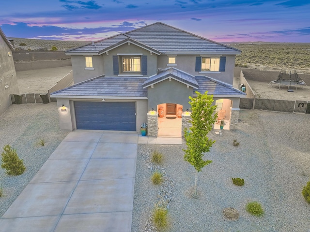 2350 Sandra Loop NE, Rio Rancho, NM 87144 - traditional home with stucco siding, concrete driveway, and a garage