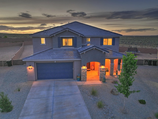 2350 Sandra Loop NE, Rio Rancho, NM 87144 - traditional-style home with stucco siding, an attached garage, driveway, and a tiled roof
