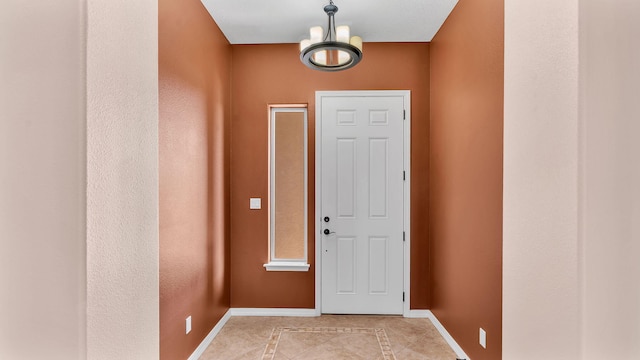 4281 Palo Verde Ct, Los Lunas, NM 87031 - entryway featuring baseboards, light tile patterned floors, and a chandelier