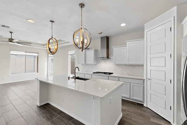 215 Adeline Ave, Los Lunas, NM 87031 - kitchen featuring wall chimney range hood, backsplash, light countertops, recessed lighting, and a ceiling fan