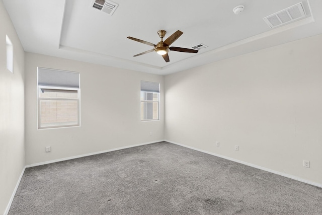 215 Adeline Ave, Los Lunas, NM 87031 - empty room featuring a tray ceiling, ceiling fan, carpet flooring, and a smoke detector