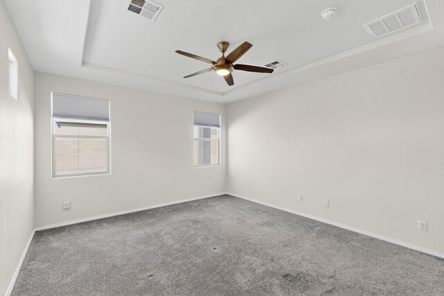 215 Adeline Ave, Los Lunas, NM 87031 - empty room with a raised ceiling, a ceiling fan, healthy amount of natural light, and carpet