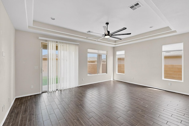 275 Adeline Ave, Los Lunas, NM 87031 - empty room with a raised ceiling, ceiling fan, and dark wood-type flooring
