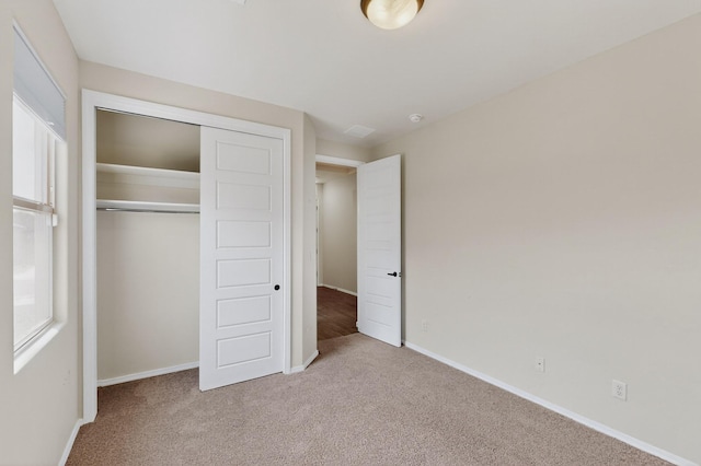 275 Adeline Ave, Los Lunas, NM 87031 - unfurnished bedroom featuring carpet, a closet, and multiple windows