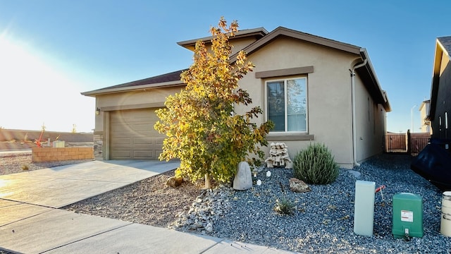315 Adeline Ave, Los Lunas, NM 87031 - view of front of property featuring stucco siding, driveway, and an attached garage