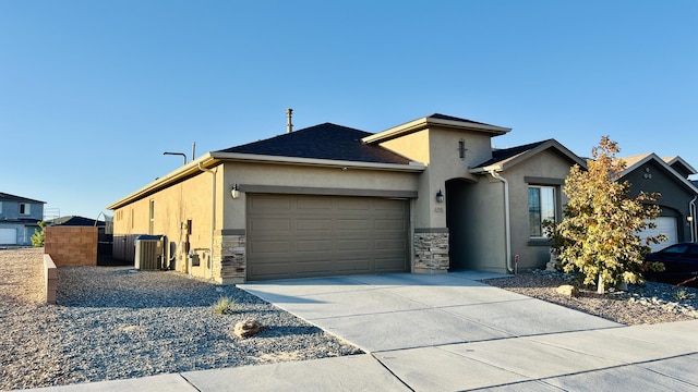315 Adeline Ave, Los Lunas, NM 87031 - view of front of house featuring stucco siding, stone siding, a garage, and concrete driveway