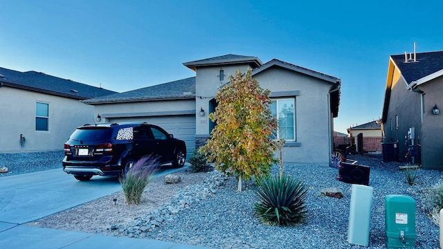 395 Adeline Ave, Los Lunas, NM 87031 - view of front of home with a garage, stucco siding, and driveway