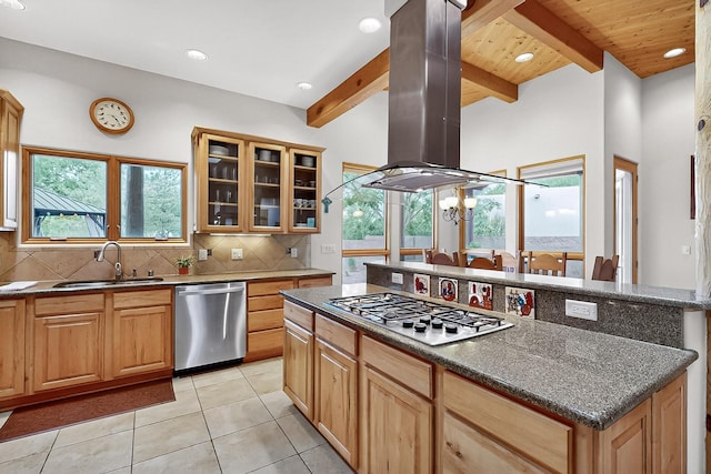 317 Plaza Muchomas, Bernalillo, NM 87004 - kitchen featuring appliances with stainless steel finishes, island exhaust hood, tasteful backsplash, light tile patterned floors, and glass insert cabinets