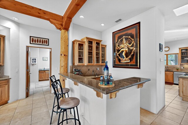 317 Plaza Muchomas, Bernalillo, NM 87004 - bar featuring light tile patterned floors, decorative backsplash, stainless steel dishwasher, and recessed lighting
