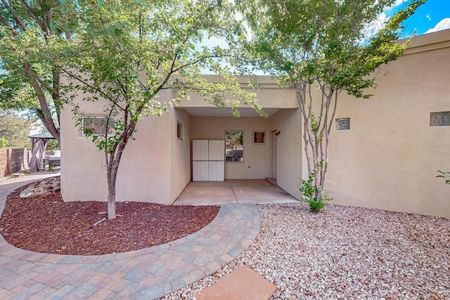 317 Plaza Muchomas, Bernalillo, NM 87004 - property entrance featuring stucco siding