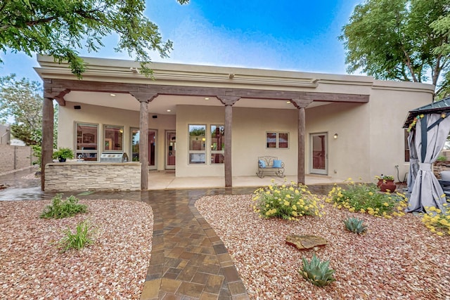 317 Plaza Muchomas, Bernalillo, NM 87004 - rear view of property featuring stucco siding, a patio, and a gazebo