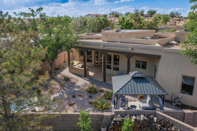 317 Plaza Muchomas, Bernalillo, NM 87004 - back of house featuring a gazebo, a patio area, stucco siding, and a fenced backyard
