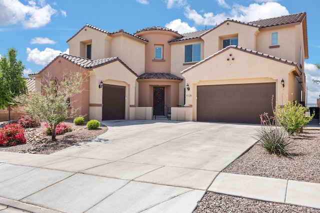 9128 Vista Bosquejo Rd NW, Albuquerque, NM 87120 - mediterranean / spanish house featuring an attached garage, stucco siding, a tile roof, and driveway