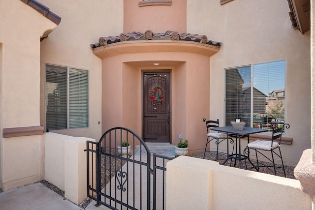 9128 Vista Bosquejo Rd NW, Albuquerque, NM 87120 - entrance to property with a gate, stucco siding, and a tiled roof