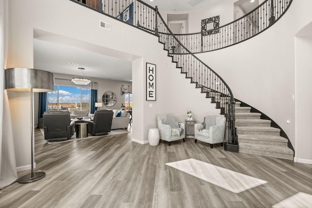 9128 Vista Bosquejo Rd NW, Albuquerque, NM 87120 - entryway with stairway, wood finished floors, a towering ceiling, and a chandelier