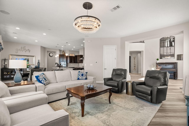 9128 Vista Bosquejo Rd NW, Albuquerque, NM 87120 - living area with light wood finished floors, a chandelier, and recessed lighting